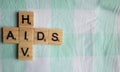 AIDS HIV in wooden block letters on bed Royalty Free Stock Photo
