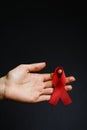 Aids ribbon on hands, hiv Royalty Free Stock Photo