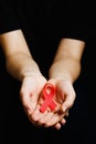 Aids ribbon on hands, hiv Royalty Free Stock Photo