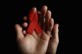 Aids ribbon on hands, hiv Royalty Free Stock Photo