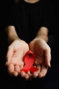 Aids ribbon on hands, hiv Royalty Free Stock Photo