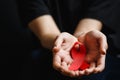 Aids ribbon on hands, hiv Royalty Free Stock Photo