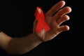 Aids ribbon on hands, hiv Royalty Free Stock Photo