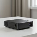 aigeneratedA compact, black rectangular projector sits on a white table. It has a smooth surface Royalty Free Stock Photo