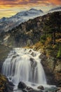 Aigualluts sinkhole waterfall Forau d`Aigualluts, with the peak of Aneto in the background, Benasque, in the Pyrenees of Huesca