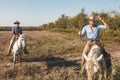 Aigues-Mortes, Camargue, Southern France, September 19, 2018. The Cowboys, riding on beautiful white horses, greeting tourists who Royalty Free Stock Photo