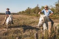 Aigues-Mortes, Camargue, Southern France, September 19, 2018. The Cowboys, riding on beautiful white horses, greeting tourists who Royalty Free Stock Photo