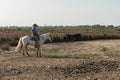 Aigues-Mortes, Camargue, Southern France, September 19, 2018. The Camargue Cowboys, riding on beautiful Camargue white horses Royalty Free Stock Photo