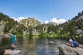 Hikers relaxing at the mountain lake. Aigues tortes park. Spain