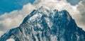 Aiguille Verte in close-up with snow topped mountain and clouds in the background