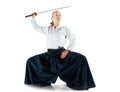 Aikido master practices defense posture. Healthy lifestyle and sports concept. Woman in white kimono on white background