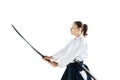 Aikido master practices defense posture. Healthy lifestyle and sports concept. Woman in white kimono on white background