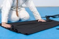 An aikidoka girl folding her hakama for Aikido training Royalty Free Stock Photo