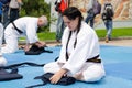 Aikidoka girl folds her hakama after a show Royalty Free Stock Photo