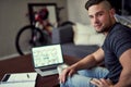 Aim high, work hard. Portrait of a happy young man using his laptop to work from home. Royalty Free Stock Photo