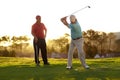 Aiming for the green. Two male golfers going through a round of golf. Royalty Free Stock Photo