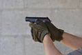 Aiming and Shooting .45 Caliber 1911 Hand Gun with Gloves Royalty Free Stock Photo