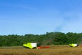 Two agricultural machines operate in the field, grain harvesting machines operate in the field, agricultural land Royalty Free Stock Photo