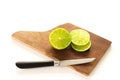 Caipirinha. A brazilian drink made with lime, cachaÃÂ§a, sugar and ice. wood background. slices of lemon, and a knife.