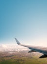 Aiplane window view with ariplane wing, landscape and blue sky copy space Royalty Free Stock Photo