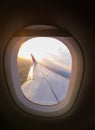 Aiplane sunrise windows view on aircraft wing from the cabin, skyline transportation