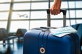 Air or airplane travel during pandemic concept with hand luggage and masks in an airport terminal