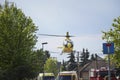 The air ambulance, service arrives at the scene of an accident. Flying yellow medical ambulance helicopter. Background of blue sky