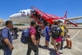 Tourist passengers are getting on an Air Asia Low-Cost Airlines aircraft