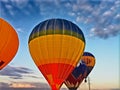 Air balloon flying in the blue sky. Vibrant air balloons float exhibition in the countryside field.