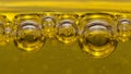 Air balls, of different sizes, in a yellow, viscous liquid, tend to the surface Royalty Free Stock Photo