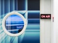 ON AIR board message is lit on the door of the recording studio, with circle window with Europe 1 logo, french famous radio