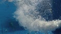 Air bubbles in clear blue water in pool Royalty Free Stock Photo