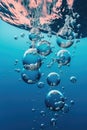 air bubbles rising in clear blue water Royalty Free Stock Photo
