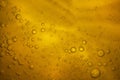 Air bubbles in subtle golden liquid. Background. Royalty Free Stock Photo