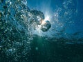 Air bubbles at water surface in sea in clear blue water Royalty Free Stock Photo