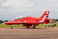 An Air Cadet waves from her back seat of a Red Arrow