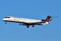 Air Canada Express Aircraft landing in blue sky background