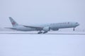 Air Canada plane landing on Munich Airport MUC, snow on runway