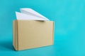 Air cargo concept. Paper plane on craft box on blue background Royalty Free Stock Photo