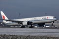 Air China plane taking off from runway, snow on runway