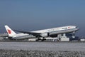 Air China plane taking off from runway, snow on runway