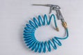 Air Compressor Blow Gun with Coiled Blue Hose Royalty Free Stock Photo