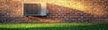 Air Conditioner on Brick Wall, Sunset Light, 3D Render, Grass, HVAC, Cooling System. HVAC, 3D rendering Royalty Free Stock Photo