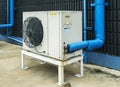 Air conditioner compressor installed in black wall building Royalty Free Stock Photo