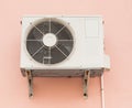 Air Conditioner Compressor Unit on Orange Wall Royalty Free Stock Photo