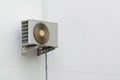 Air conditioner compressor unit on white wall. Royalty Free Stock Photo