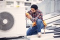Air conditioner, happy and technician man ac repair, maintenance or inspection of electrical heat pump or generator Royalty Free Stock Photo