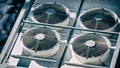 air conditioner heat pump white fans vent rooftop splitters rotating background Royalty Free Stock Photo