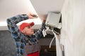 Air conditioner service. Worker at climatization system installation indoors Royalty Free Stock Photo