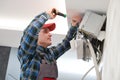 Air conditioner service. Worker at climatization system installation indoors Royalty Free Stock Photo